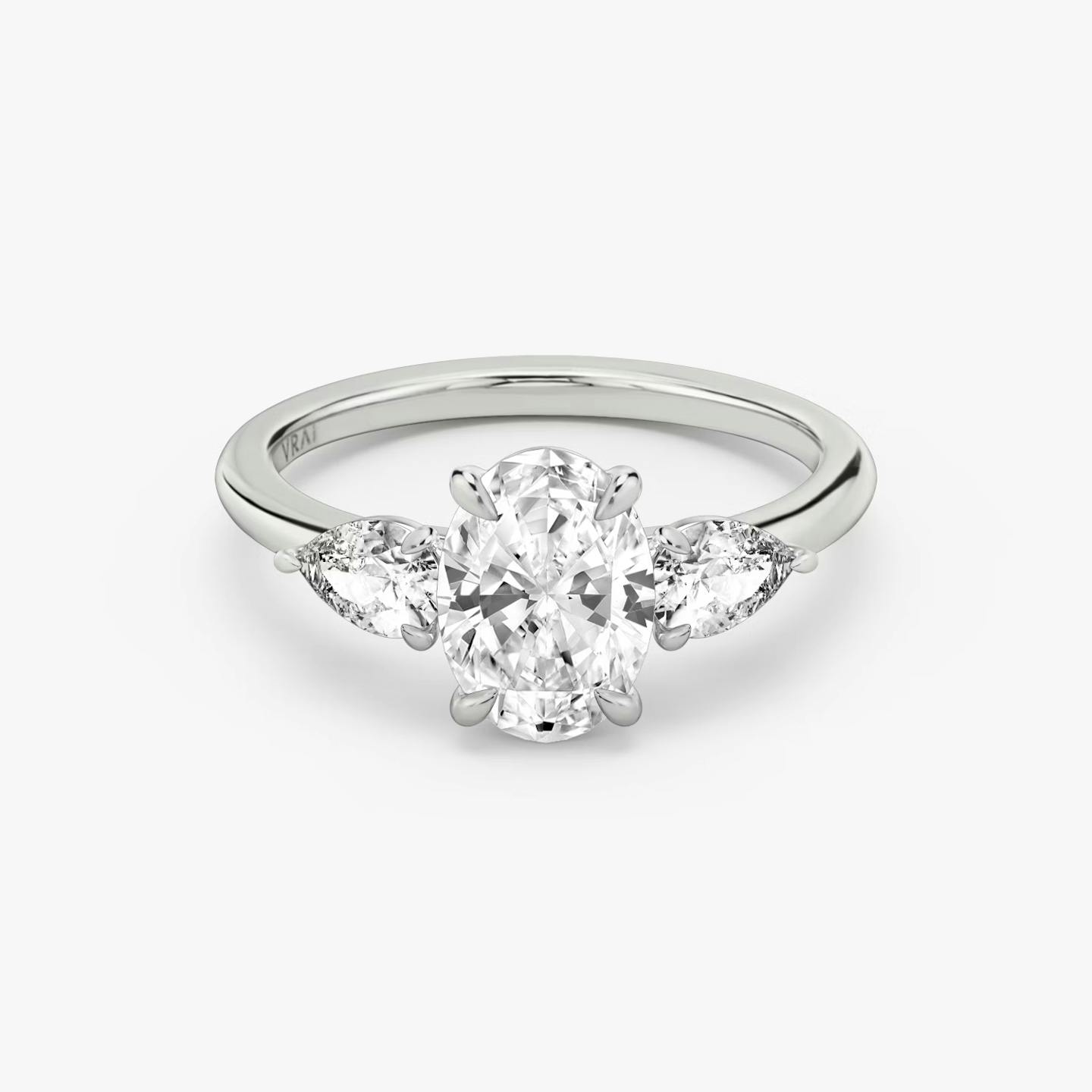 The Three Stone | Oval | Platinum | Band: Plain | Side stone carat: 1/4 | Side stone shape: Pear | Diamond orientation: vertical | Carat weight: See full inventory